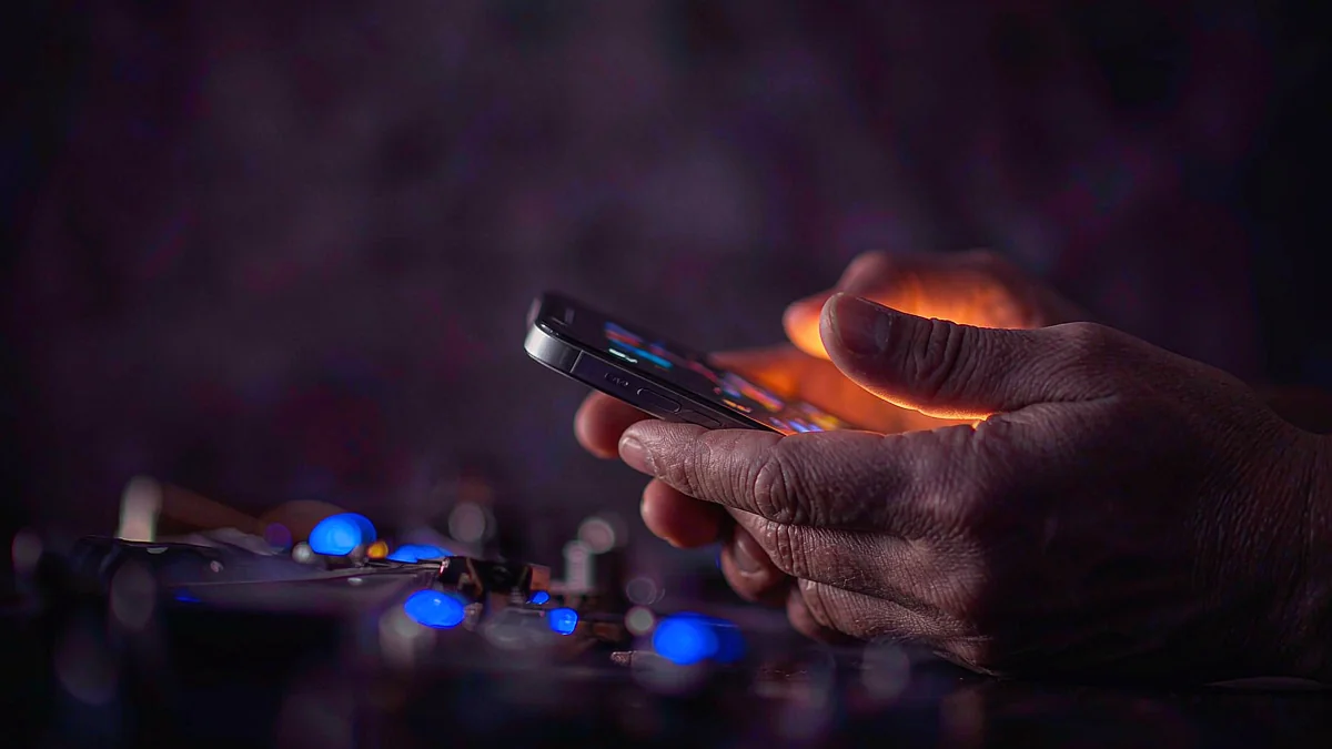 Hands holding a smartphone in warm light